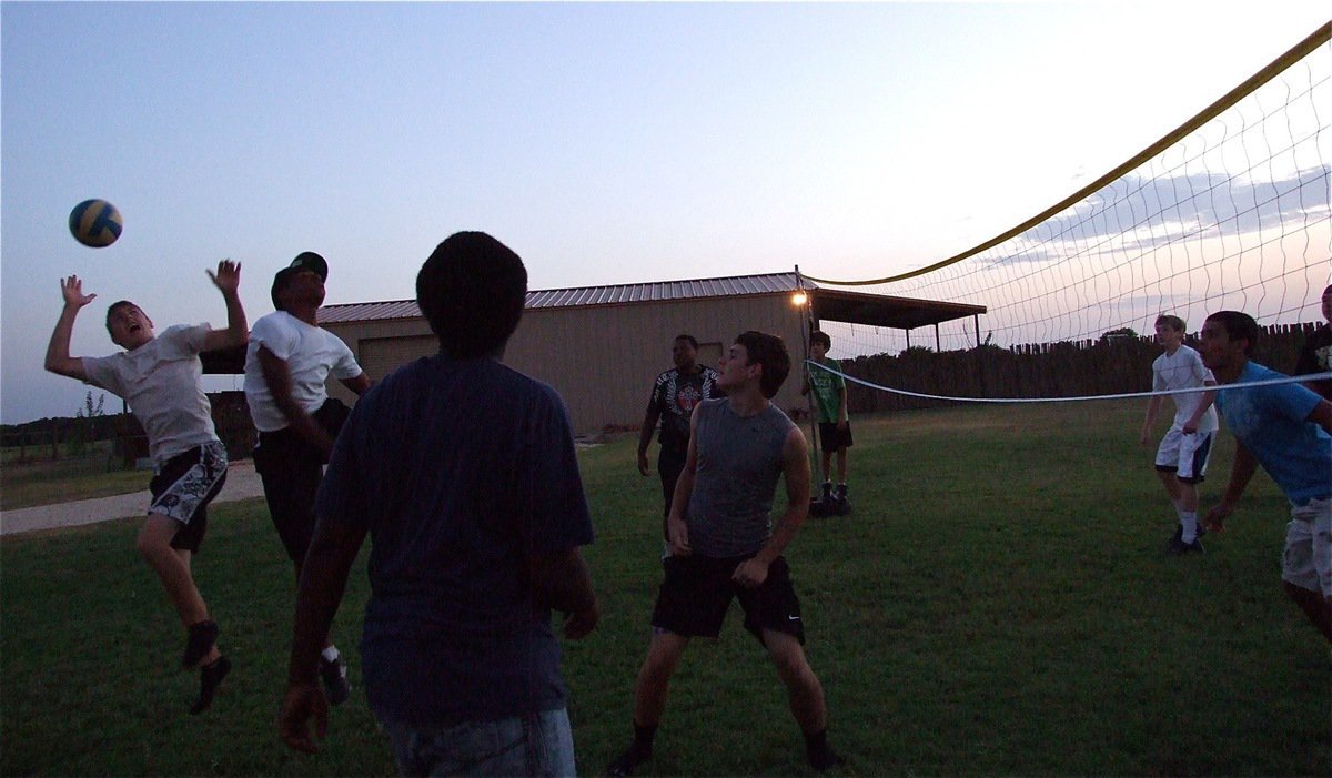 Image: Brandon Connor and Jaray Anderson go after a ball during a volleyball game amongst school mates.