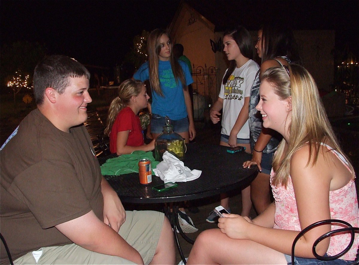 Image: Zac Mercer and Tia Russell have some laughs during the bash.