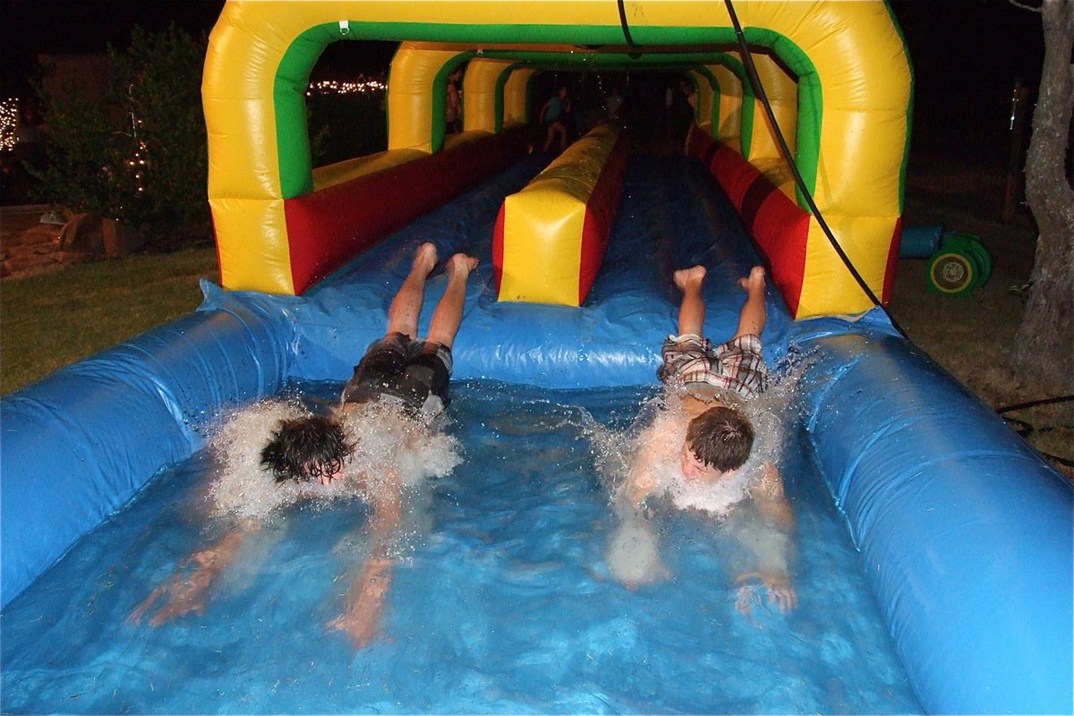 Image: Kyle Fortenberry on the left edges John Escamilla at the finish on the slip-n-slide.