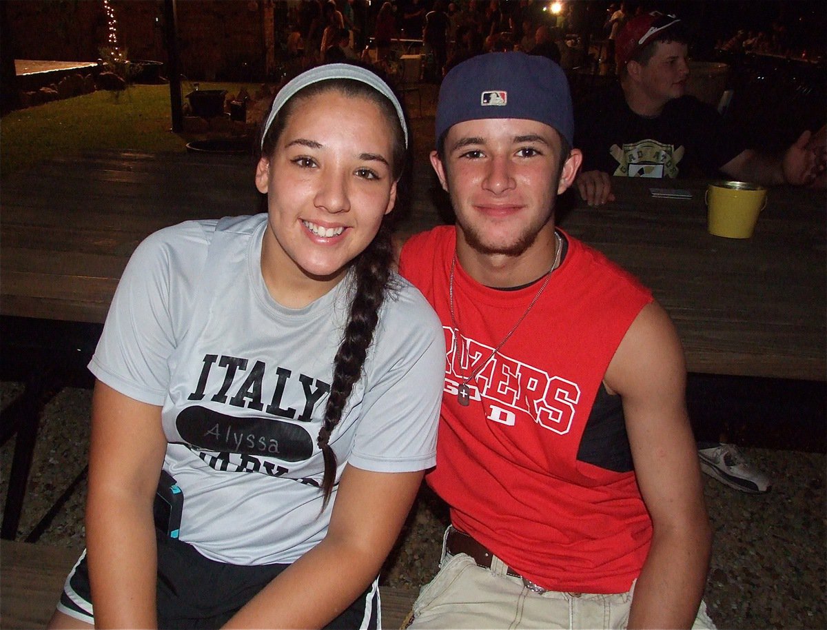 Image: Alyssa Richards and Caden Jacinto relax at the picnic table while watching the goings on.