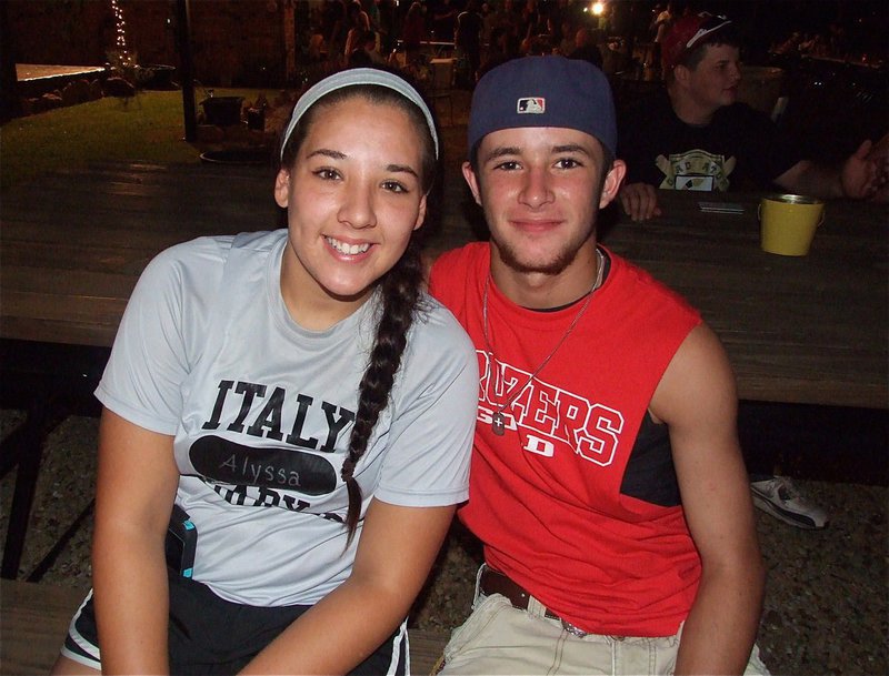 Image: Alyssa Richards and Caden Jacinto relax at the picnic table while watching the goings on.