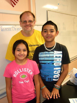 Image: Richard Harvel (6th grade teacher) with his new student Marcos Duarte and his sister Zenaide Duarte (5th grade).