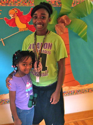 Image: Toni Darrough (1st grade) and 11th grader Ragene Miles are ready for school. Toni can’t wait to learn math and reading.