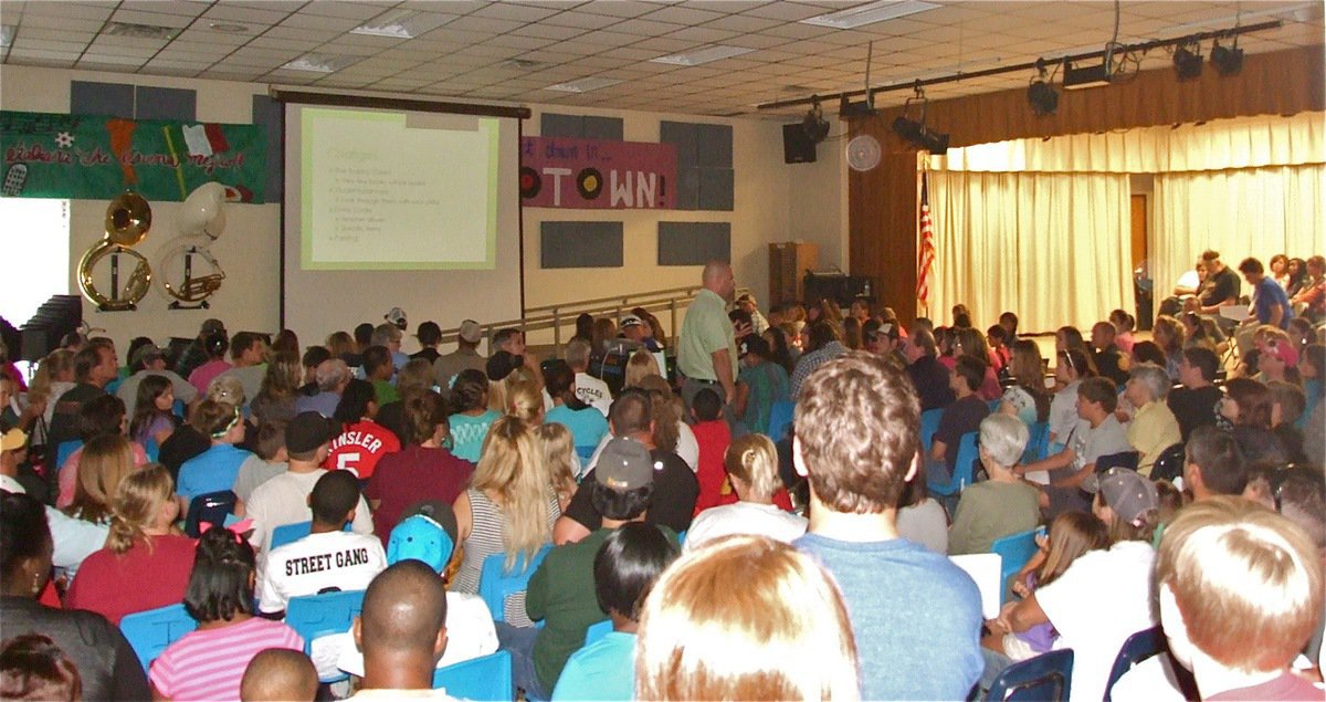 Image: Italy High School Principal, Lee Joffre, presents a slide show to parents and students that addresses important information regarding the upcoming school year during Meet the Teacher Night at Italy High School.