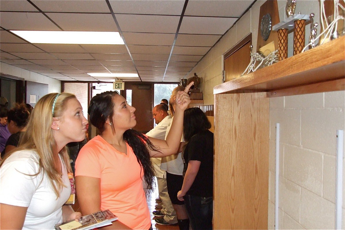 Image: IHS student athletes Jaclynn Lewis and Alyssa Richards admire the new trophy cases.