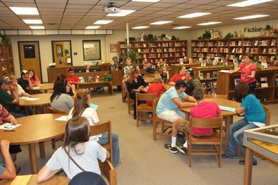 Image: IHS Librarian Mrs. Sharon Farmer discusses library procedures with those attending.