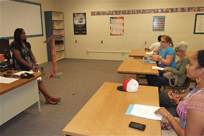 Image: Jessica Robinson goes over her course objectives with students and parents during Meet the Teacher Night at Italy High School.