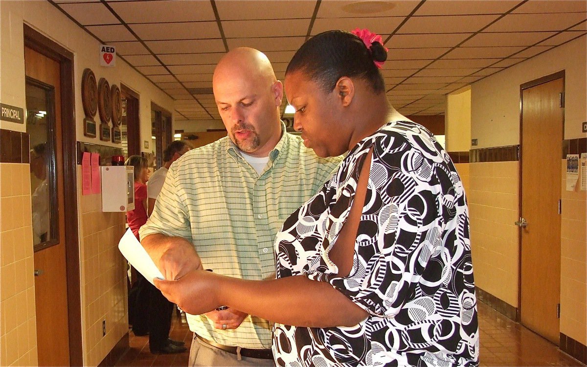 Image: Principal Lee Joffre discusses the schedule with IHS Alumni Brendetta Reed.