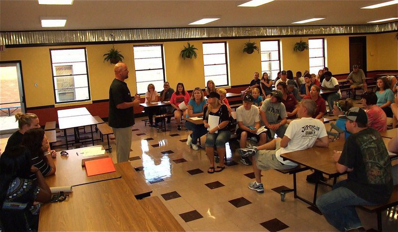 Image: AD/Head Football Coach Hank Hollywood talks with visitors regarding the sports programs and long-term goals.