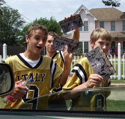 Image: Italy JV Gladiator Football players Levi McBride(9), Ryan Connor(15) and Clayton Miller(80) participate in the team’s Sales Blitz campaign to sell restaurant coupons.