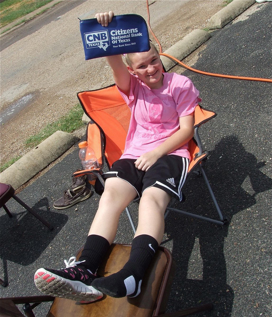 Image: Lady Gladiator Tara Wallis collects donations during the car wash.