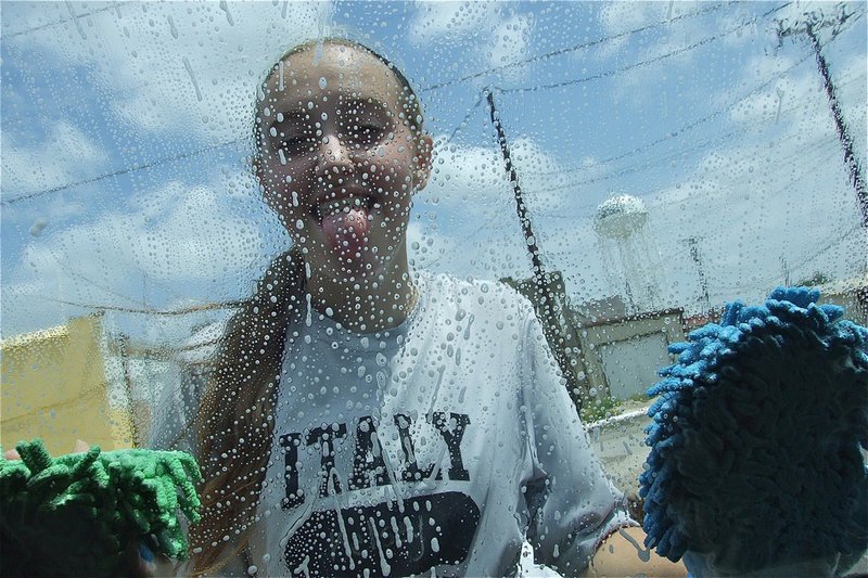 Image: Kelsey Nelson and her teammates are having good clean fun during the Lady Gladiator Volleyball Car Wash.