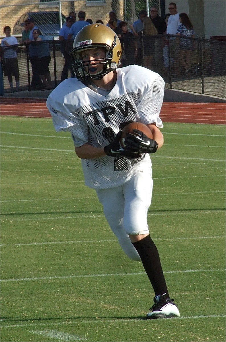 Image: Clayton Miller pulls in a pass from his quarterback Ryan Connor during warmups.