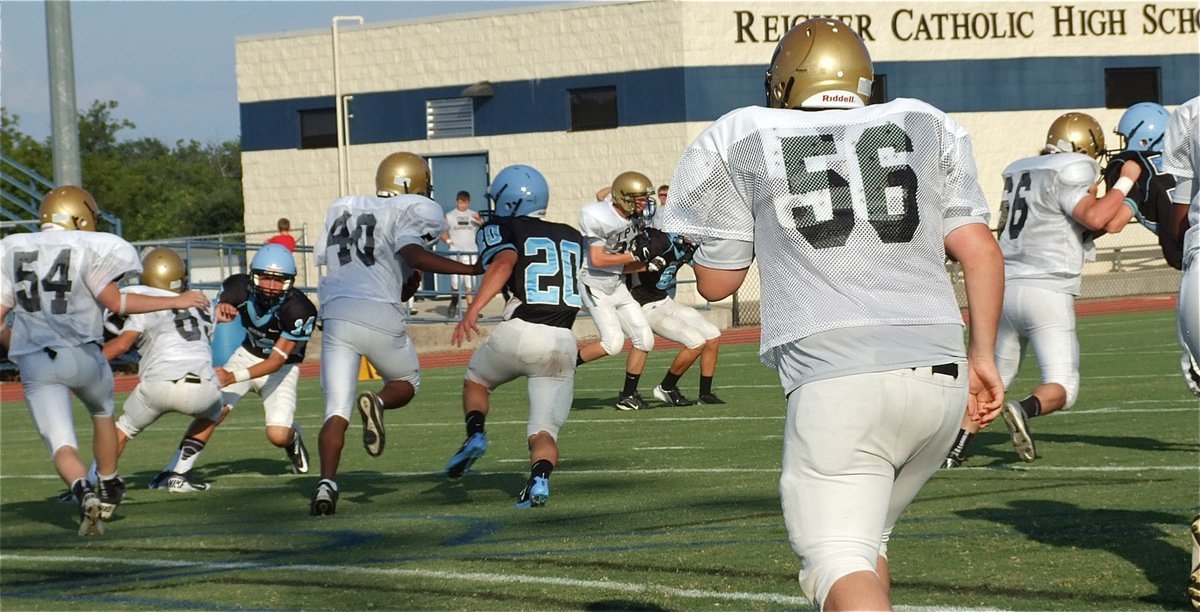 Image: Jaray Anderson(40) stiff arms his way downfield for more yardage.