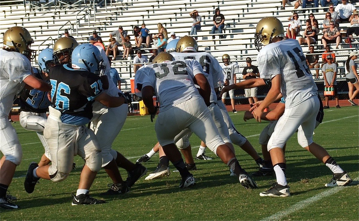 Image: Billy Moore(32) takes the handoff from Ryan Connor(15) and plows ahead for the tough yards.