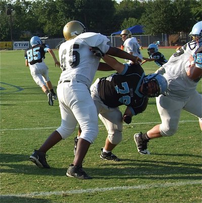 Image: Offensive guard Justin Robinson(65) proves to the 3A Cougars that 1A Italy is no push over.
