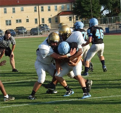 Image: There are times when I wish a still photo came with sound. This picture really doesn’t do justice to the loud pop that Kyle Forternberry(66) and Justin Robinson(65) put on this Cougar running back.