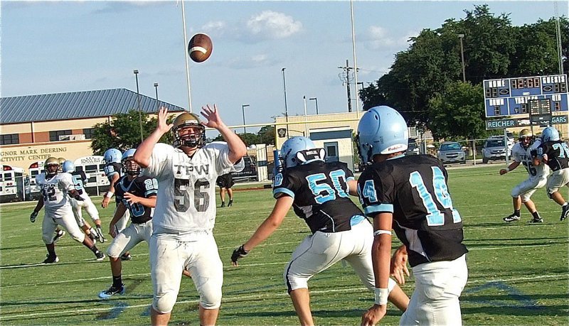 Image: Right defensive tackle John Byers(56) leaps and batts down a Cougar pass attempt to turn the ball back over to the JV Gladiators.