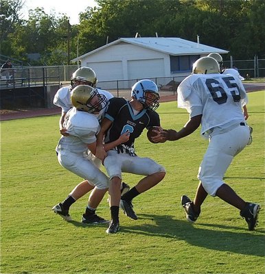 Image: Another hard tackle applied by linebacker John Escamilla(54) keeps the Cougars from reaching the endzone.