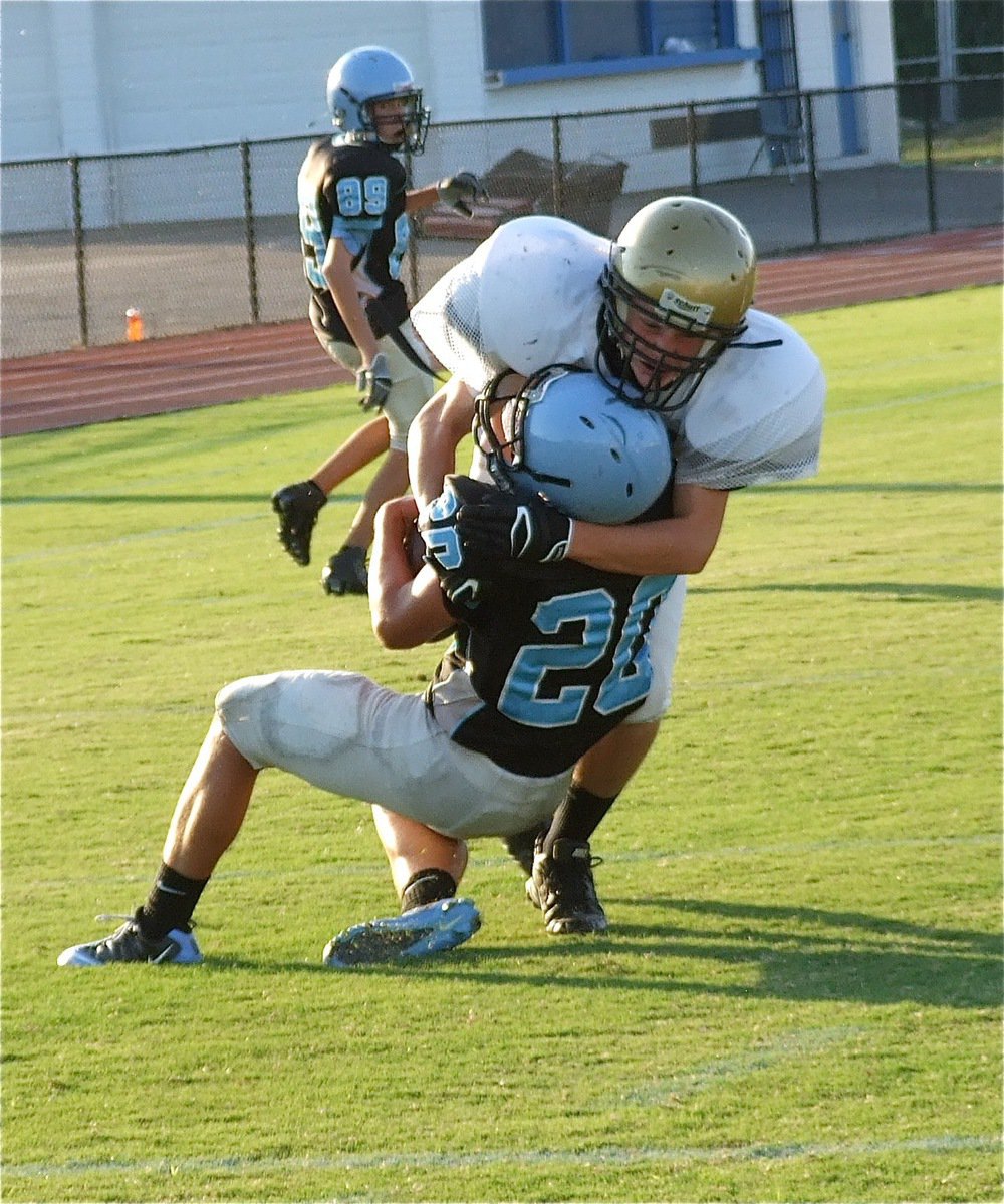 Image: Cornerback Cody Boyd(30) loudly scuffs up the powder blue helmet on this unsuspecting Cougar running back for one of the game’s biggest hits.