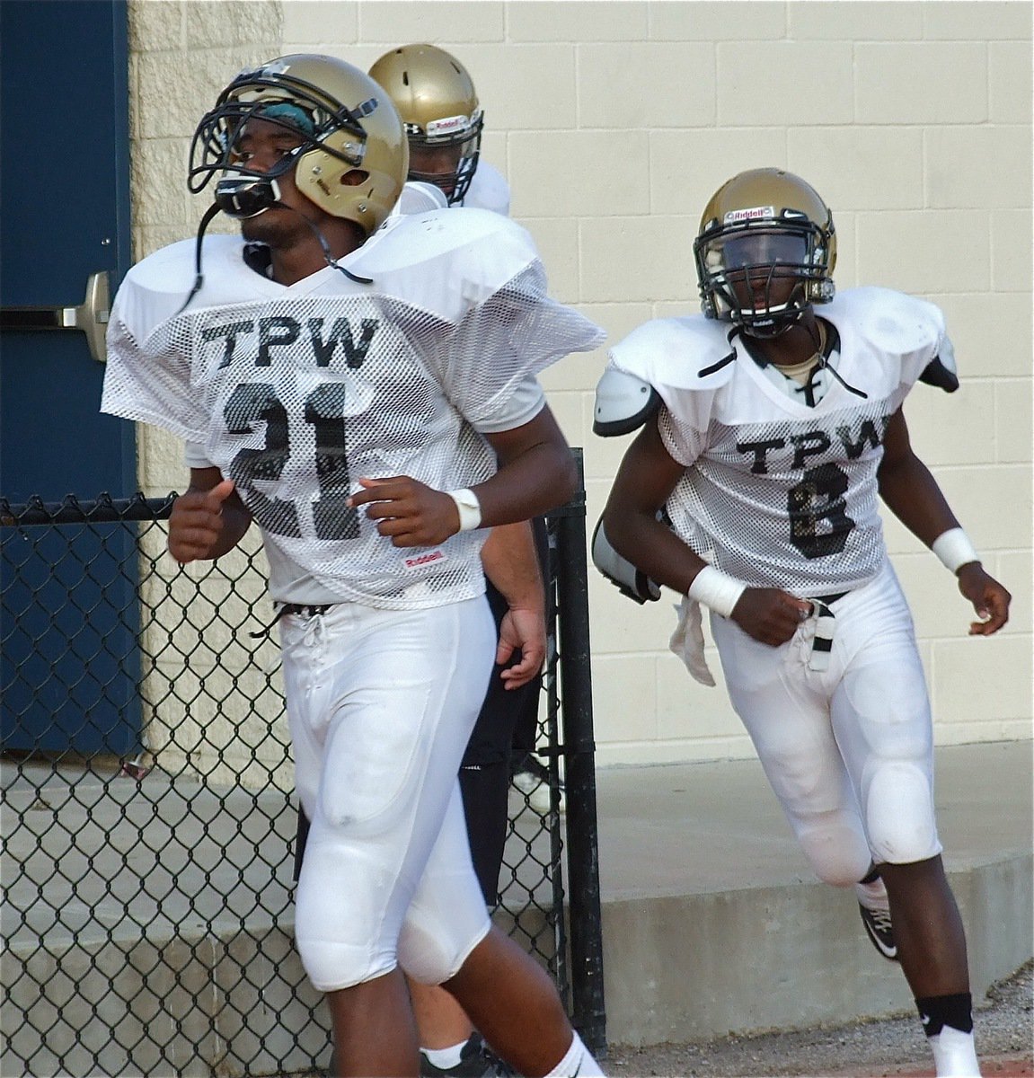 Image: Italy Gladiator seniors Paul Harrsi(21) and Marvin Cox(6) charge the field to take on the Waco Reicher Cougars.