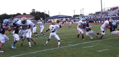 Image: Eric Carson(7) stays in the pocket while Ryheem Walker(22), Cody Medrano(58), Darol Mayberry(56), Zackery Boykin(55), Kevin Roldan(60) and Zain Byers(55) protect.