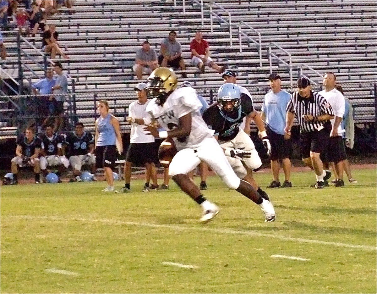 Image: Quarterback Marvin Cox(6) tucks and runs thru the Cougar defense.