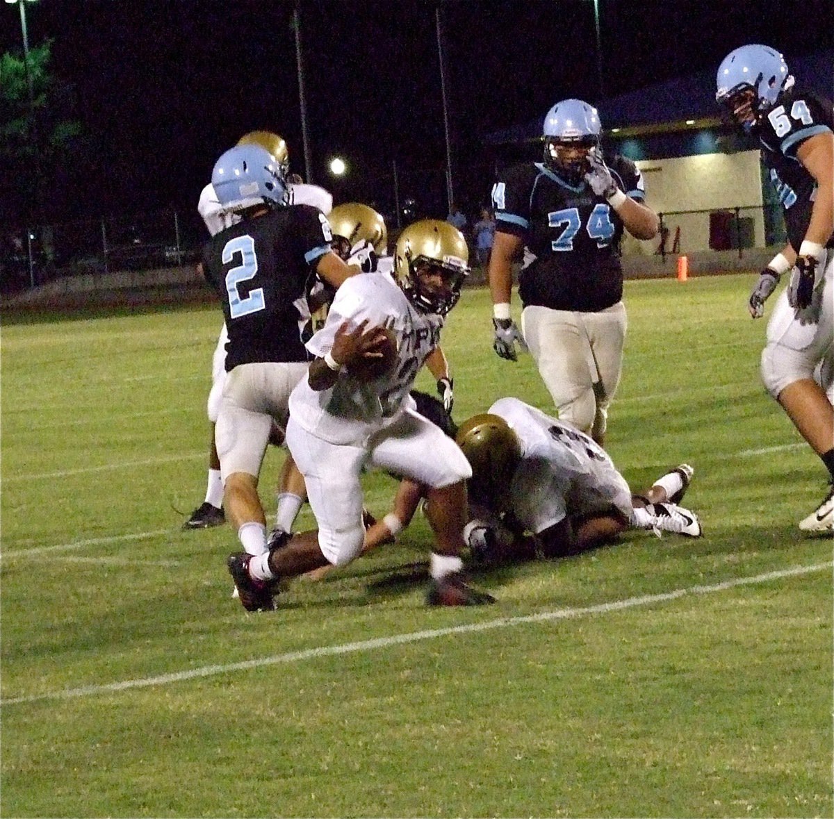 Image: During the game simulated 12-minute quarter, outside linebacker Jalarnce Lewis(21) strips the ball away from the Cougars and sprints some 50-yards for a Gladiator touchdown.