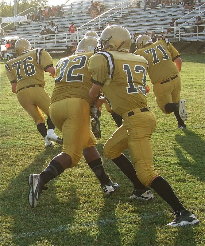 Image: JV quarterback Ryan Connor(13) helps his offense polish their offensive plays before the game.