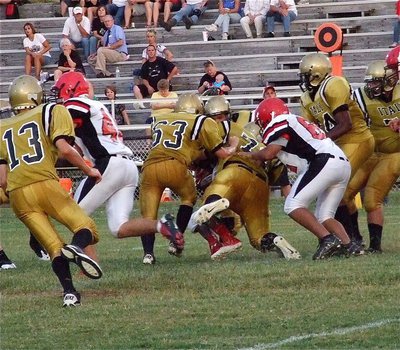 Image: John Escamilla(63) and John Byers(71) bring down a Panther runner.