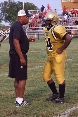Image: Line coach Larry Mayberry instructs Justin Robbins(64).