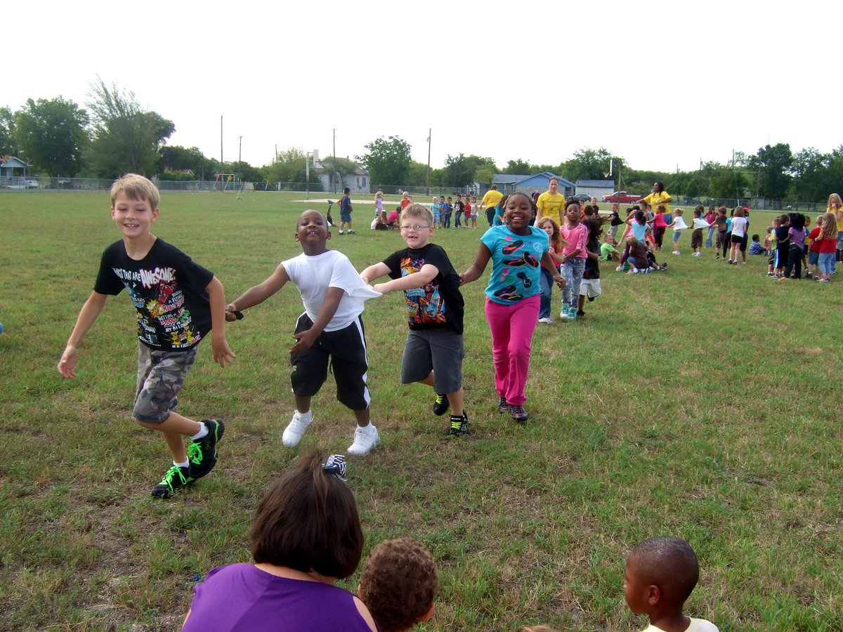 Image: The kids are having fun playing Dragon Tag. The idea is to keep together and tag another team without breaking a part.