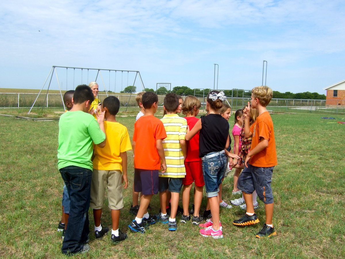 Image: These team players were trying to get everyone lined up smallest to tallest without saying a word.