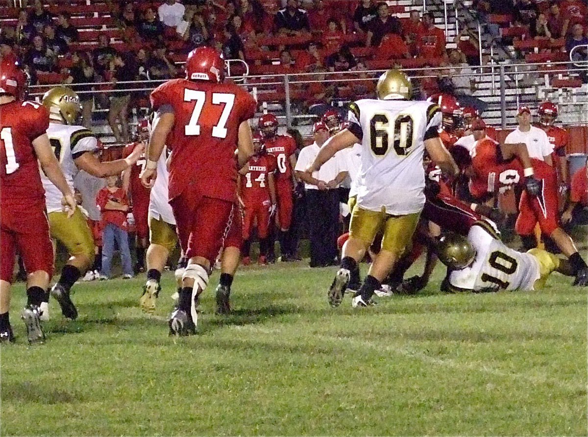 Image: Gladiator defender Ryheem Walker(10) hangs on to a Maypearl runner before Kevin Roldan(60) cleans up with a big hit.