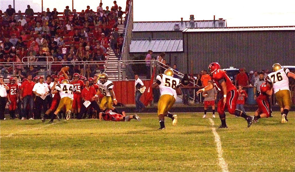 Image: Italy’s Justin Wood(44) reaches Maypearl’s quarterback to force an incomplete pass with help from Cody Medrano(75).