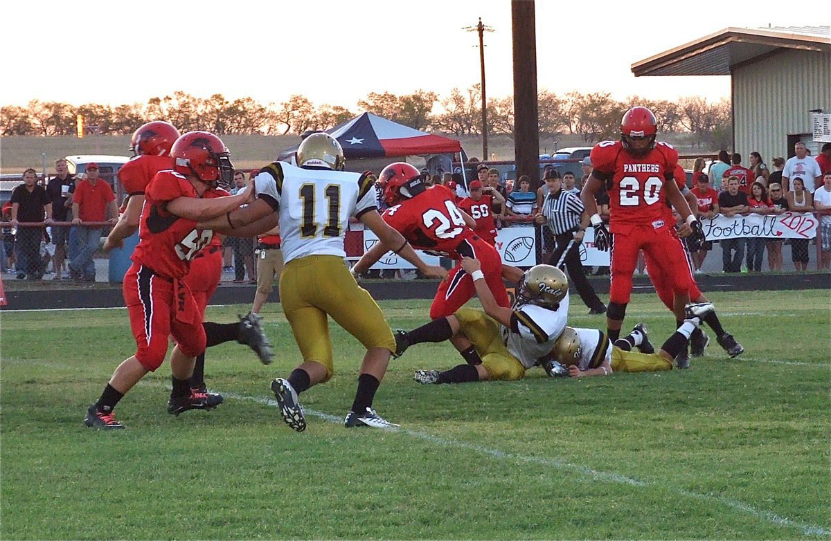 Image: Italy’s Zain Byers(50) and Caden Jacinto(6) pull down a Panther with teammate Reid Jacinto(11) rushing in.