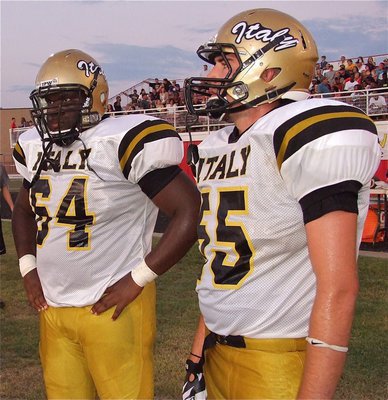 Image: Adrian Reed(64) and Zackery Boykin(55) take a short breather on the Gladiator sideline.