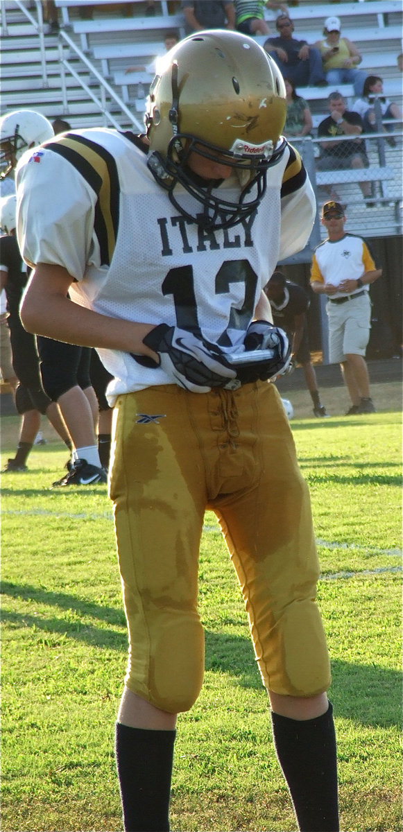 Image: Italy’s Ty Windham(12) checks the play call.