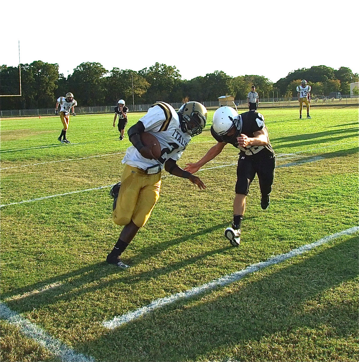 Image: Helmet-to-helmet: Marvin Cox(2) gets knocked out-of-bounds after a long gain.