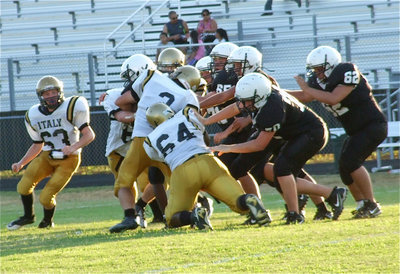 Image: Hunter Merimon(3), Kyle Fortenberry(66) and Justin Robbins(64) bring down a Tiger runner.