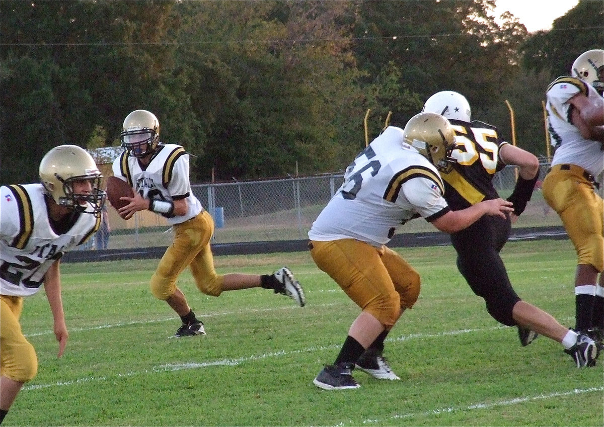 Image: Italy’s John Byers(56) blocks for quarterback Ryan Connor(13) as he rolls out to pass.