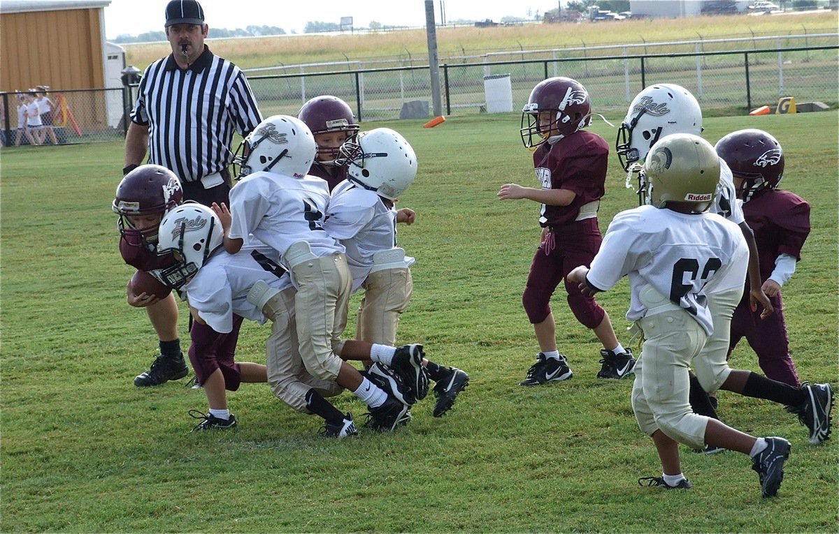 Image: Lane Shifflett(4), Jaylon Wallace(8) and Damien Wooldridge(5) bring down a Mildred back in the Eagle’s backfield as the IYAA C-Team Gladiators shutout Mildred 21-0 in the season opener at Willis Field.