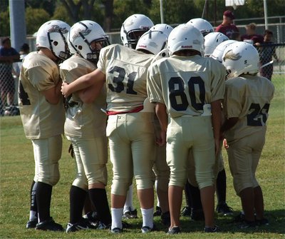 Image: The IYAA B-Team offense unites together in the huddle.