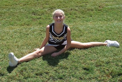Image: IYAA A-team cheerleader Courtney Riddle does the splits.