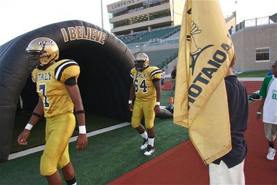 Image: Senior Gladiators Paul Harris(7) and Adrian Reed(64) take the field during pre-game warmups.