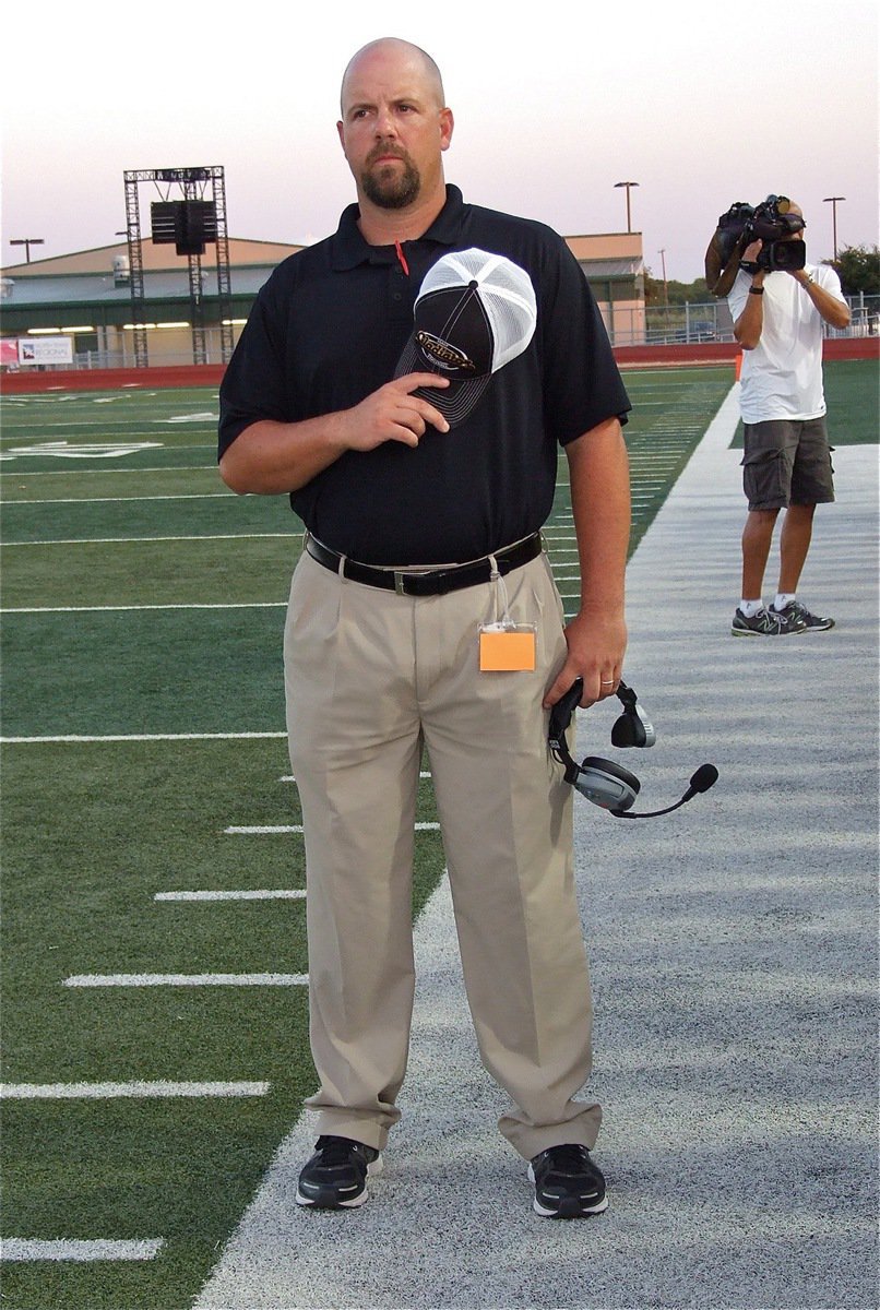 Image: Italy High School Athletic Director and Head Football Coach Hank Hollywood has his game face on during the playing of the National Anthem.