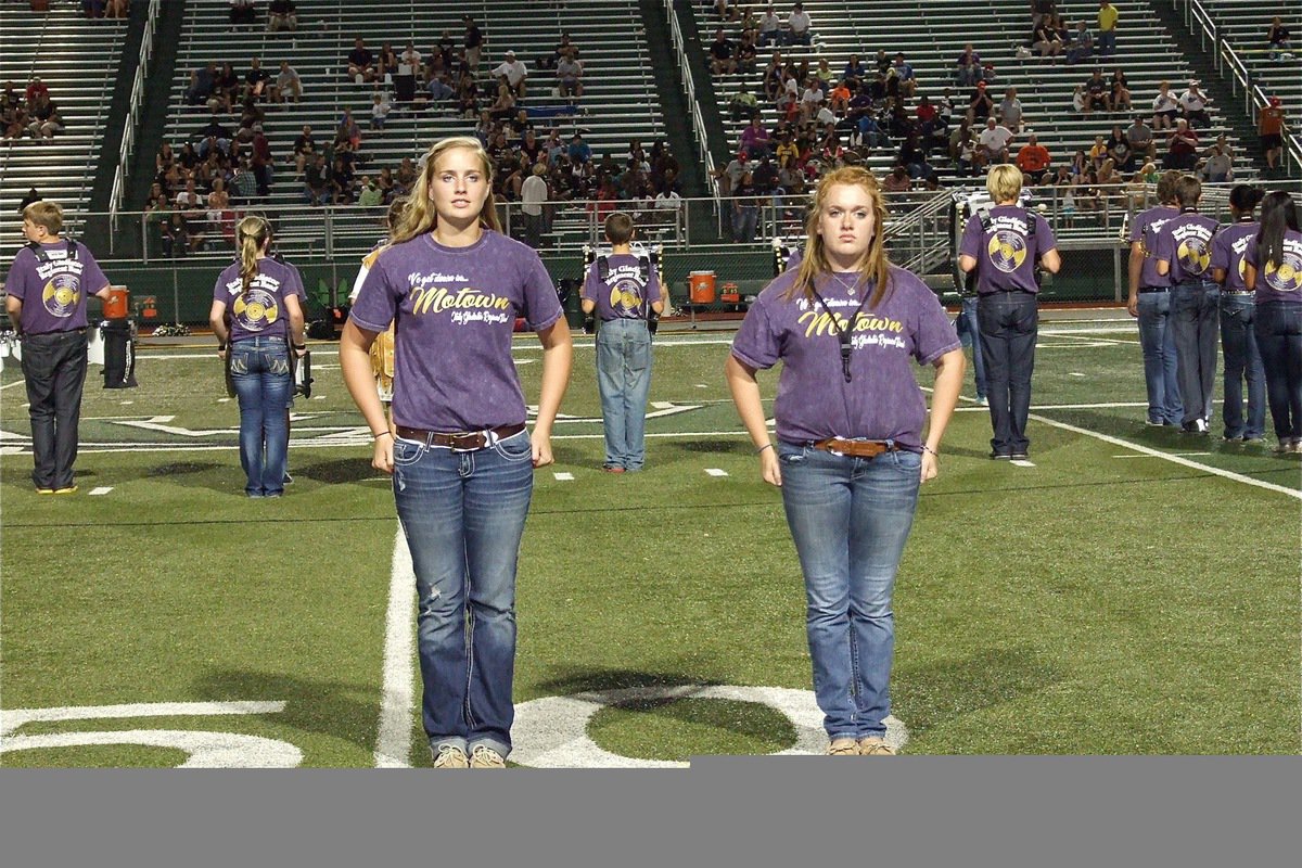 Image: Assistant drum major Madison Washington and drum major Emily Stiles get the band in position to perform.