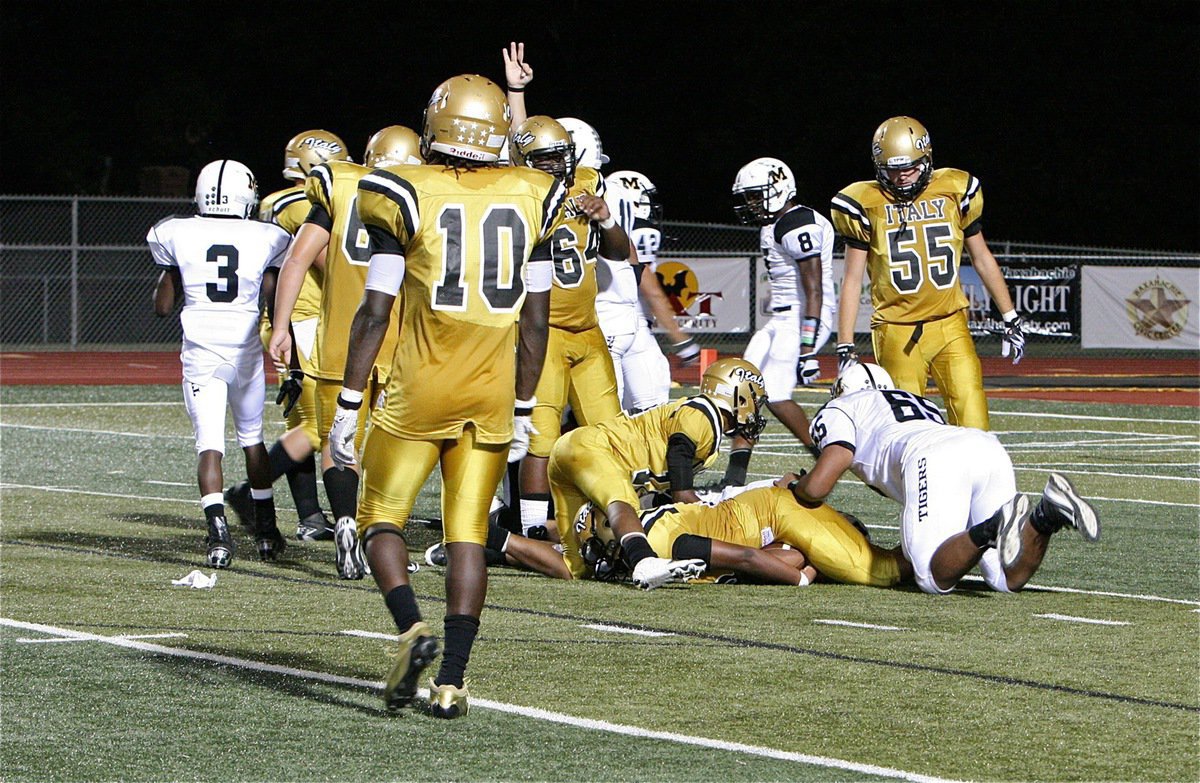 Image: Left tackle Darol Mayberry(58) secures a fumble to keep possession of the ball for Italy’s offense.