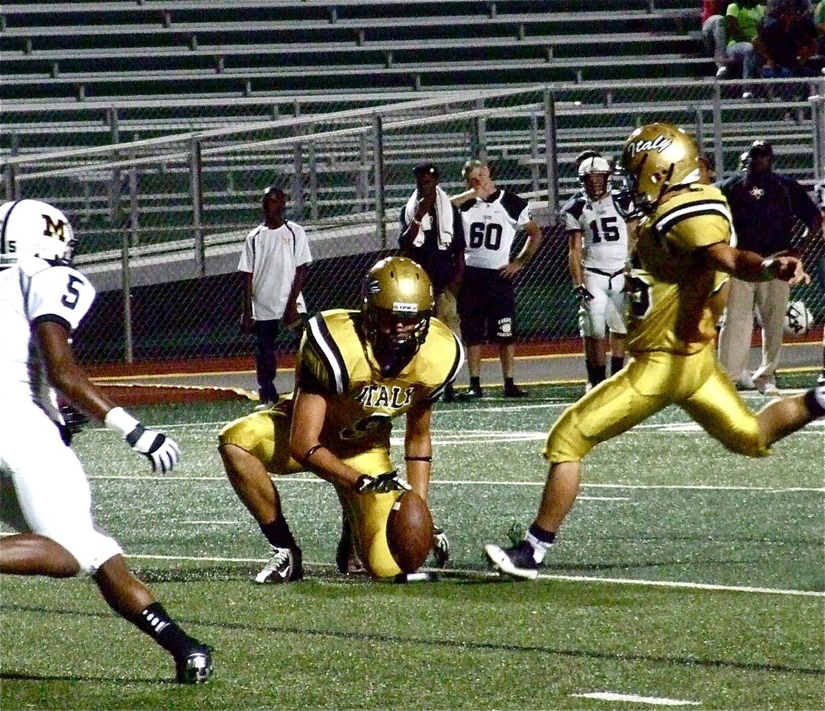 Image: Cole Hopkins takes the snap from Justin Wood and holds while Braulio Luna(56) kicks the point after thru the uprights. Luna’s kick tied the score 36-36 in the third quarter but Malakoff went on to win big, 64-36.