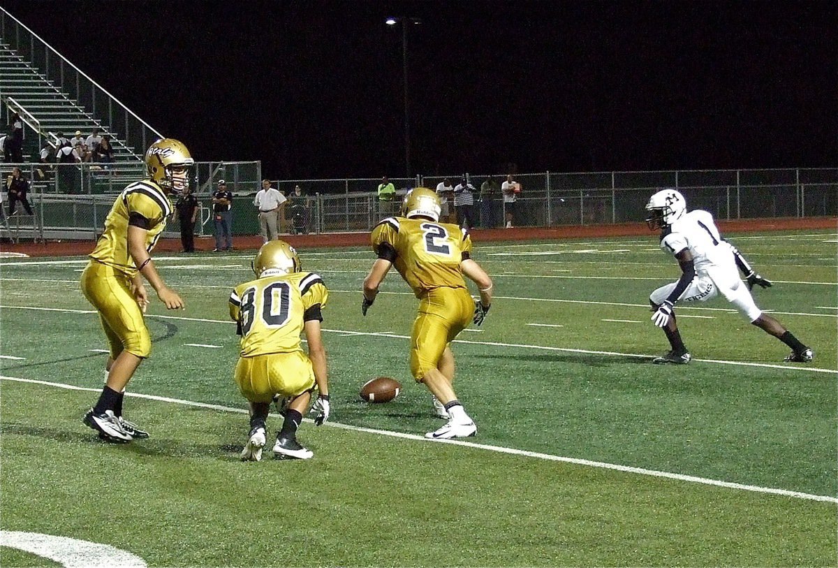 Image: Reid Jacinto(11), Kelvin Joffre(80) and Chase Hamilton(2) pounce on a Cole Hopkins punt before the Tigers can return it.